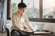 © amnaj - Young Asian businessman working on a laptop at the office.