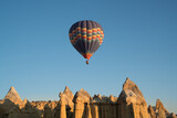 Fototapeta Góry - Balloons flying in Cappadocia, Göreme at sunrise. Cappadocia is known around the world as one of the best places to fly with hot air balloons.  Turkey.