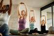 © Drazen - Below view of athletic women doing Yoga relaxation exercise while practicing in health club.
