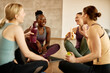 © Drazen - Happy black athletic woman having fun with her friends while taking a break from exercising in health club.