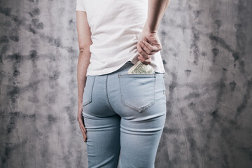 Wall Mural - Woman hand putting money in jeans pocket