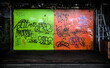 Graffiti covers the green and orange neon-colored doors of a garage in central Osaka