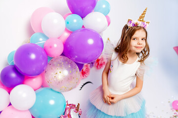 Unicorn Girl posing near air baloons. Idea for decorating unicor