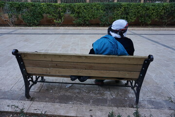 Canvas Print - man sitting on a bench