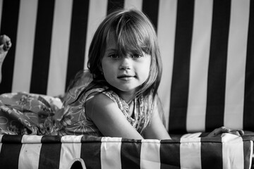 Wall Mural - Portrait of cute girl near a country house. Black and white photo.