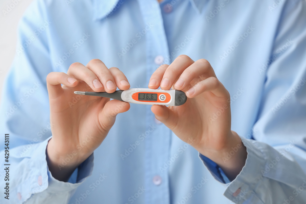 Woman with electronic thermometer, closeup