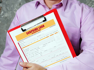 Business concept about SUBPRIME LOAN Application Form with inscription on bank form.