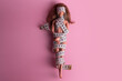 Doll wrapped in measuring tape. Tied up unrecognizable plastic doll, weight loss, fasting and slimming, diet, anorexia, overeating control, female fight for perfect fit body concept. Free copyspace