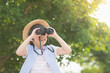 © lalalululala - Cute asian child looks in binoculars outdoors in sunny summer day