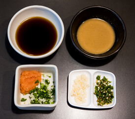 Wall Mural - Dipping ponzu sauce with garlic, chili pepper and green onion and white sesame sauce