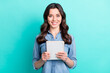 © deagreez - Photo of happy attractive nice young woman hold hand notebook smile isolated on pastel teal color background