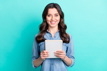 Poster - Photo of happy attractive nice young woman hold hand notebook smile isolated on pastel teal color background