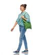 © Syda Productions - sustainability and people concept - smiling asian woman in turquoise shirt and jeans with green reusable canvas bag for food shopping walking over white background