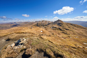 Poster - The mountain summits of Meall nan Tarmachan, Meall Garbh and Ben Lawers in the distance from the top of Beinn nan Eachan in the spring. Scottish Highlands, UK Landscapes.