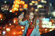 © paffy - Teen girl on cityscape background making self portrait with her smart phone