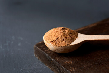 Wall Mural - camu-camu powder in a wooden spoon