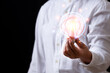 © Ake Studio - Business  hand holding light bulb technology creative new idea innovation brainstarming and solution business copy space background, thinking inspiration design  professional success conceptual.
