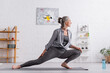 © LIGHTFIELD STUDIOS - side view of flexible middle aged woman practicing yoga on mat
