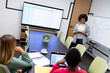 © wavebreak3 - African american businesswoman giving presentation to diverse group of colleagues in meeting room
