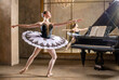 © Maria Moroz - Young ballerina in a white tutu dancing on beautiful old piano in a vintage interior