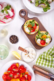 Fototapeta Kuchnia - Round crispbread toast with greens and vegetables. Healthy food concept.