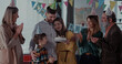 © Fractal Pictures - Happy multi-generation family of four members celebrating birthday party with candle cake blowing and enjoying reunion holiday.
