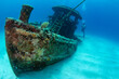 Woman diver on the wreck of a small tugboat off Grand Case on the French island of St Martin