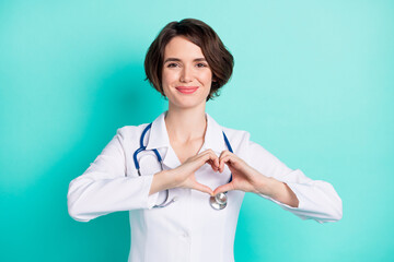 Canvas Print - Photo of young woman happy positive smile show fingers hear sign medicine doctor isolated over teal color background