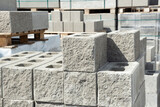 Fototapeta Do przedpokoju - Stack of cement concrete Building cinder blocks brick  on pallete in hardware store with decorative stone texture side