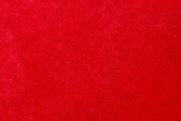 texture smooth velvet fabric of red color shine in the sun