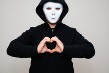 Hacker With Anonymous Mask Making Gesture Of Heart