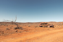 The Rusted Abandoned Wreck Of An Old Car In A Remote Area Of Australian Outback On A Rural Dirt Road Near Fowlers Gap, NSW