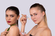 © Viorel - Aloe vera cosmetic products. Two charming, diverse caucasian women, looking to camera holding green leaf and cosmetic product cream mask with brush. Aloe fresh juice, spa gel, wet beauty cosmetology