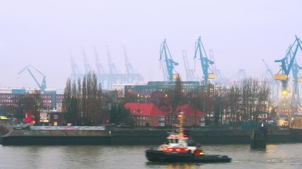 Wall Mural - Hamburg, Germany. Port of Hamburg on the river Elbe in Germany in the morning. Huge industrial cranes with cloudy misty sky, zoom in