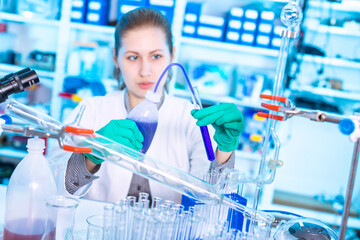 Canvas Print - Young woman in a pharmacological laboratory. Antiallergic drug development and research