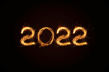 New Year 2022 light. Sparklers draw figures 2022. Bengal lights and letter