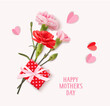 Happy Mothers day greeting text. Holiday design template with realistic pink carnation flowers, gift box and paper hearts on pink background. Vector stock illustration.