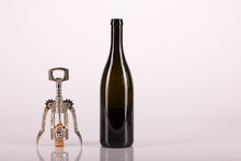 Red Wine Bottle, Cork Stopper And An Italian Prestigious Corkscrew On A White Background