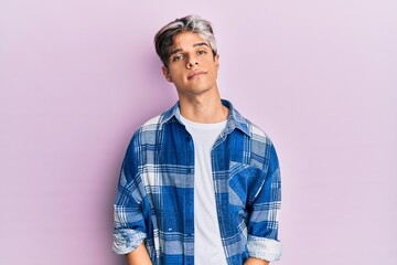 Sticker - Young hispanic man wearing casual clothes relaxed with serious expression on face. simple and natural looking at the camera.