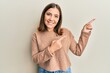 © Krakenimages.com - Young caucasian woman wearing casual winter sweater shouting and screaming loud to side with hand on mouth. communication concept.