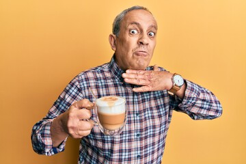 Sticker - Handsome senior man with grey hair drinking a cup coffee cutting throat with hand as knife, threaten aggression with furious violence