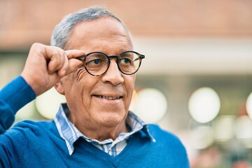 Wall Mural - senior grey-haired man smiling happy standing at the city.