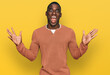 © Krakenimages.com - Young african american man wearing casual clothes celebrating victory with happy smile and winner expression with raised hands