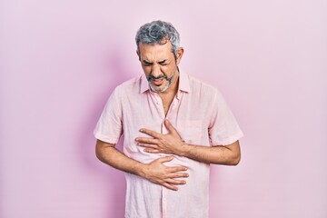 Sticker - Handsome middle age man with grey hair wearing casual shirt with hand on stomach because nausea, painful disease feeling unwell. ache concept.