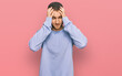 © Krakenimages.com - Young caucasian man wearing casual clothes with hand on head for pain in head because stress. suffering migraine.