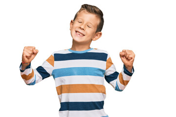 Wall Mural - Adorable caucasian kid wearing casual clothes very happy and excited doing winner gesture with arms raised, smiling and screaming for success. celebration concept.