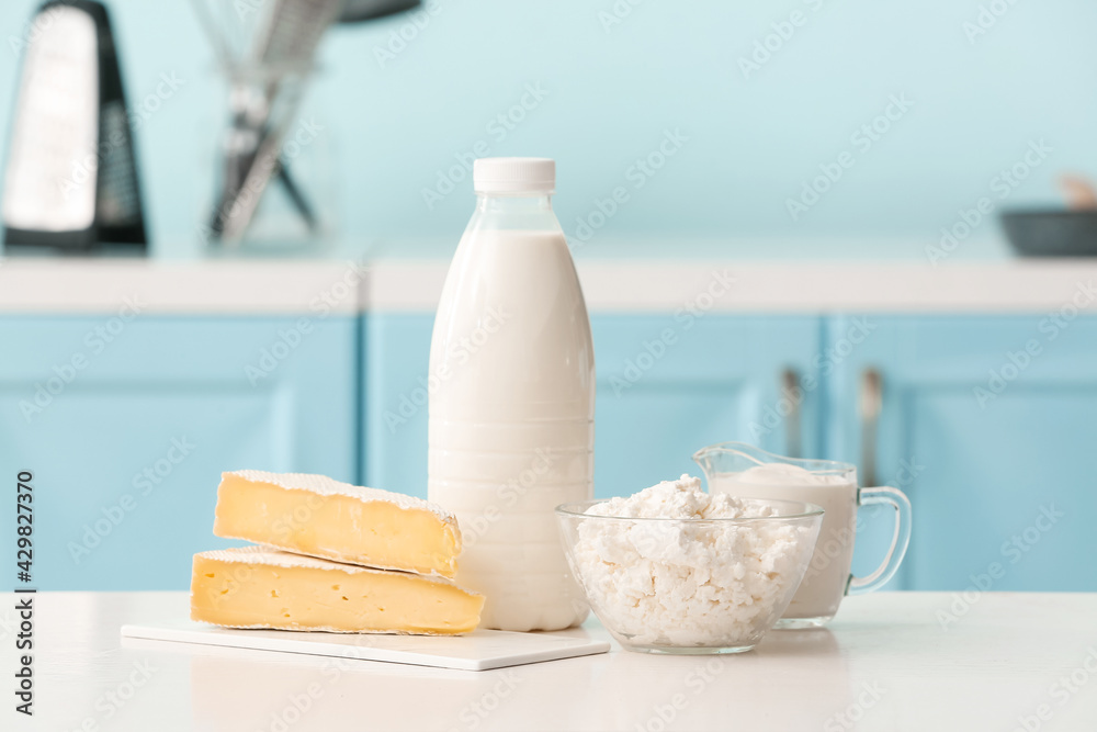 Different dairy products on table in kitchen
