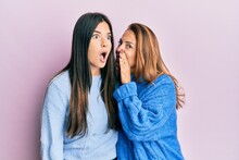 Hispanic Family Of Mother And Daughter Wearing Wool Winter Sweater Hand On Mouth Telling Secret Rumor, Whispering Malicious Talk Conversation