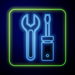 Glowing neon Screwdriver and wrench spanner tools icon isolated on blue background. Service tool symbol. Vector