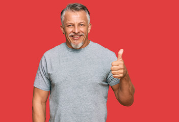 Sticker - Middle age grey-haired man wearing casual clothes smiling happy and positive, thumb up doing excellent and approval sign